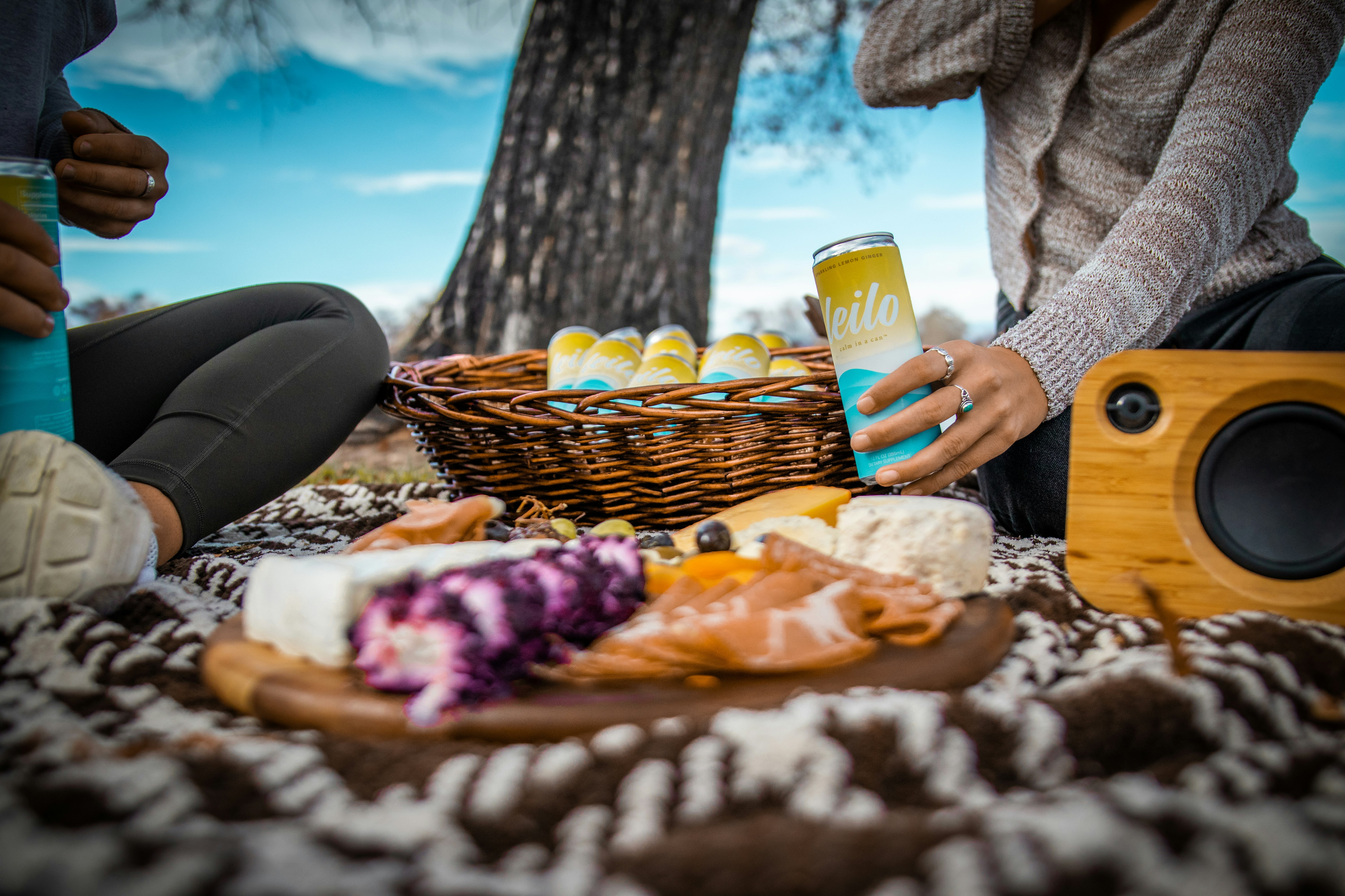 person holding blue ceramic mug near brown wicker basket with bread